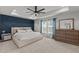 Spacious main bedroom with a tray ceiling, accent wall, carpet, and lots of natural light at 8925 Lee Brown Ridge Dr, Wake Forest, NC 27587