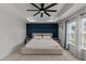 Beautiful main bedroom featuring a tray ceiling, accent wall, carpet, and natural light from the windows at 8925 Lee Brown Ridge Dr, Wake Forest, NC 27587