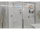 Beautiful tiled shower with glass door, built in bench, and shelving for storage of toiletries at 8925 Lee Brown Ridge Dr, Wake Forest, NC 27587