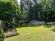 Expansive backyard with above ground pool, storage shed, and lush greenery at 924 Magnolia Ridge Way, Fuquay Varina, NC 27526
