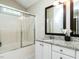 Bathroom features a shower-tub, granite counters and a large framed mirror at 924 Magnolia Ridge Way, Fuquay Varina, NC 27526