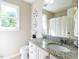 Bathroom features a granite countertop, and large mirror at 924 Magnolia Ridge Way, Fuquay Varina, NC 27526