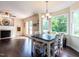 Bright dining area with hardwood floors, a wooden table set, and a view of the backyard at 924 Magnolia Ridge Way, Fuquay Varina, NC 27526