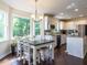 Open-concept dining area and kitchen with stainless steel appliances, granite countertops, and ample cabinet space at 924 Magnolia Ridge Way, Fuquay Varina, NC 27526