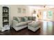 Comfortable living room with hardwood floors, a plush sofa, and natural light from the french doors at 924 Magnolia Ridge Way, Fuquay Varina, NC 27526
