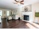 Inviting living room featuring hardwood floors, a fireplace, and a decorative stone wall at 924 Magnolia Ridge Way, Fuquay Varina, NC 27526