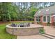 Outdoor space featuring a fire pit, patio, and well-maintained landscaping at 9900 Two Robins Ct, Raleigh, NC 27613