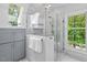 Modern bathroom featuring a glass enclosed shower with view of exterior trees at 9900 Two Robins Ct, Raleigh, NC 27613