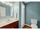 Bathroom featuring single sink vanity, a walk-in shower, and a toilet at 9900 Two Robins Ct, Raleigh, NC 27613