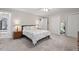 Spacious bedroom featuring a ceiling fan, carpet floors, and ensuite bath at 9900 Two Robins Ct, Raleigh, NC 27613