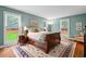 Comfortable bedroom with hardwood floors, natural light, and coordinated decor at 9900 Two Robins Ct, Raleigh, NC 27613