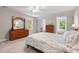Comfortable bedroom featuring ample natural light, complemented by elegant wooden furniture and a neutral color palette at 9900 Two Robins Ct, Raleigh, NC 27613