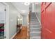 Inviting foyer with hardwood floors, a staircase, and a red front door at 9900 Two Robins Ct, Raleigh, NC 27613