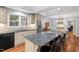 Kitchen with island seating, stainless appliances, and open floor plan at 9900 Two Robins Ct, Raleigh, NC 27613