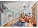 Bright living area with skylights, hardwood floors, and a cozy leather chair with ottoman at 9900 Two Robins Ct, Raleigh, NC 27613