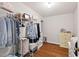 Walk-in closet featuring wire shelving, wooden floors, and a white dresser at 9900 Two Robins Ct, Raleigh, NC 27613