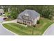 Aerial view of a beautiful large brick home surrounded by a lush lawn and mature trees at 10 Stillwood Ct, Clayton, NC 27520