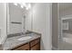 Bathroom vanity featuring granite countertop and modern fixtures, with a large mirror at 10 Stillwood Ct, Clayton, NC 27520
