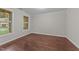 Bright and airy bedroom featuring hardwood floors and ample natural light at 10 Stillwood Ct, Clayton, NC 27520