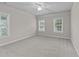 Bright bedroom with carpet, ceiling fan and bright windows at 10 Stillwood Ct, Clayton, NC 27520