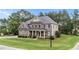 Charming two-story home with a covered front porch, landscaped yard, and attached garage at 10 Stillwood Ct, Clayton, NC 27520