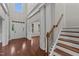 Bright and inviting foyer featuring hardwood floors, elegant staircase, and high ceilings at 10 Stillwood Ct, Clayton, NC 27520