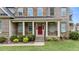 Charming front porch with brick steps, columns, and a red front door creating a welcoming entrance at 10 Stillwood Ct, Clayton, NC 27520