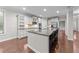 Kitchen with large island, stainless steel appliances, and white cabinetry at 10 Stillwood Ct, Clayton, NC 27520