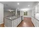 Bright kitchen with center island, stainless appliances, and open layout at 10 Stillwood Ct, Clayton, NC 27520