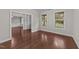 Inviting living room features hardwood floors and natural light from large windows at 10 Stillwood Ct, Clayton, NC 27520