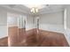 Spacious living room with coffered ceiling, wainscotting, and hardwood floors at 10 Stillwood Ct, Clayton, NC 27520