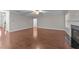 Open living room with ceiling fan, fireplace, and hardwood flooring at 10 Stillwood Ct, Clayton, NC 27520