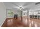 Bright open-concept living room with hardwood floors, fireplace, and access to the kitchen at 10 Stillwood Ct, Clayton, NC 27520