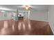 Open-concept living room with kitchen, island seating, and ample light at 10 Stillwood Ct, Clayton, NC 27520