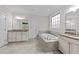 Well-lit bathroom with a garden tub and separate vanities offering functional space at 10 Stillwood Ct, Clayton, NC 27520