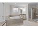 Luxurious bathroom with a garden tub, granite countertops, and glass-enclosed shower at 10 Stillwood Ct, Clayton, NC 27520