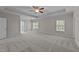 Spacious main bedroom with a tray ceiling, fan, and carpet, creating a relaxing retreat at 10 Stillwood Ct, Clayton, NC 27520