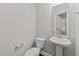 Well-lit powder room featuring pedestal sink and modern fixtures at 10 Stillwood Ct, Clayton, NC 27520
