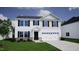 Two-story home with black shutters, stone accents and a two car garage at 100 Cordoba Dr, Franklinton, NC 27525