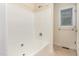 Bathroom featuring a tub and shower combo and neutral tile at 1000 Strobus Ct, Wendell, NC 27591