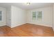A bright and spacious bedroom with wood floors and a view of the outside at 1000 Strobus Ct, Wendell, NC 27591