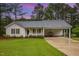 Charming home with a front porch, manicured lawn and a carport at 1000 Strobus Ct, Wendell, NC 27591