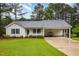 Charming single-story home featuring a well-manicured lawn and a convenient covered carport at 1000 Strobus Ct, Wendell, NC 27591