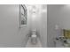 Stylish powder room featuring a decorative light fixture, a toilet, and a granite countertop at 10317 Roadstead W Way, Raleigh, NC 27613