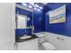 Stylish half-bath features a modern vanity, designer mirror, and chic blue accent wall at 10317 Roadstead W Way, Raleigh, NC 27613