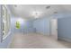 Spacious bedroom with hardwood floors, windows offering great views, and modern light fixture at 10317 Roadstead W Way, Raleigh, NC 27613