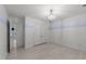 A bedroom featuring light wood floors, soft blue accent stripe, closet, a modern light fixture, and an open doorway at 10317 Roadstead W Way, Raleigh, NC 27613