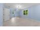Bright bedroom with hardwood floors, windows with backyard views, and a modern light fixture at 10317 Roadstead W Way, Raleigh, NC 27613