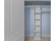 Walk-in closet features custom shelving and ample storage space with hardwood floors at 10317 Roadstead W Way, Raleigh, NC 27613