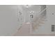 Foyer with stairs and modern metal handrail, neutral paint, and wood look floors at 10317 Roadstead W Way, Raleigh, NC 27613